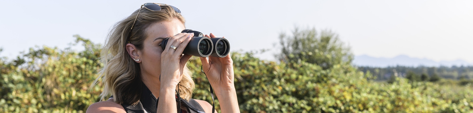 a woman on a walk looking through binoculars