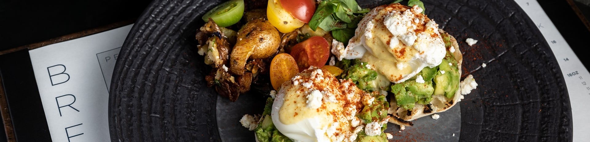 close up of Eggs Benny with Smashed Avocado, Hungarian Paprika and Feta