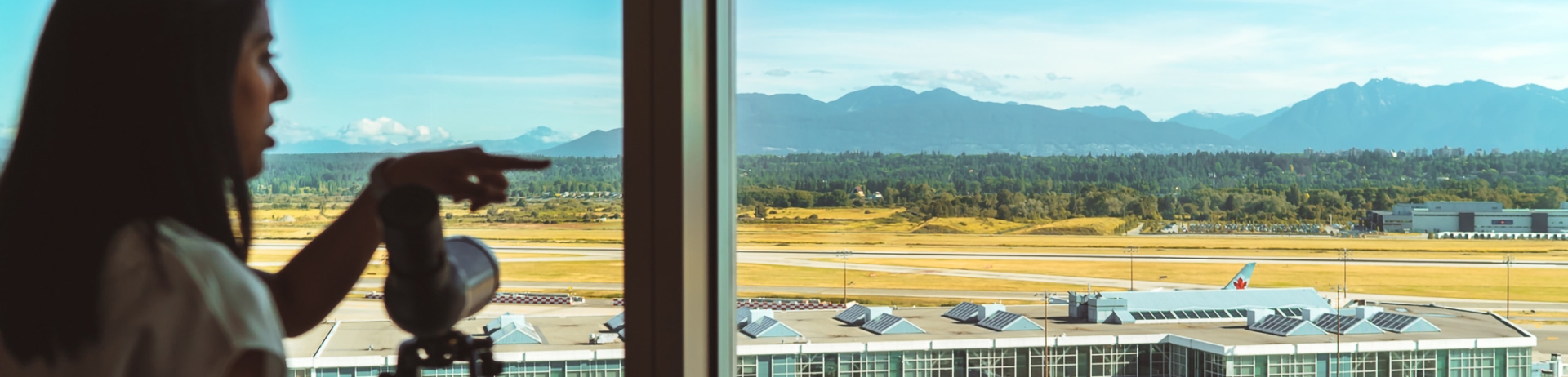 woman looking at the tarmac from her bedroom window