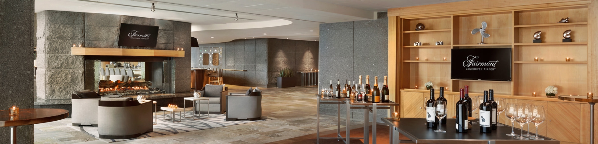 small square tables with wine glasses and bottles of wine