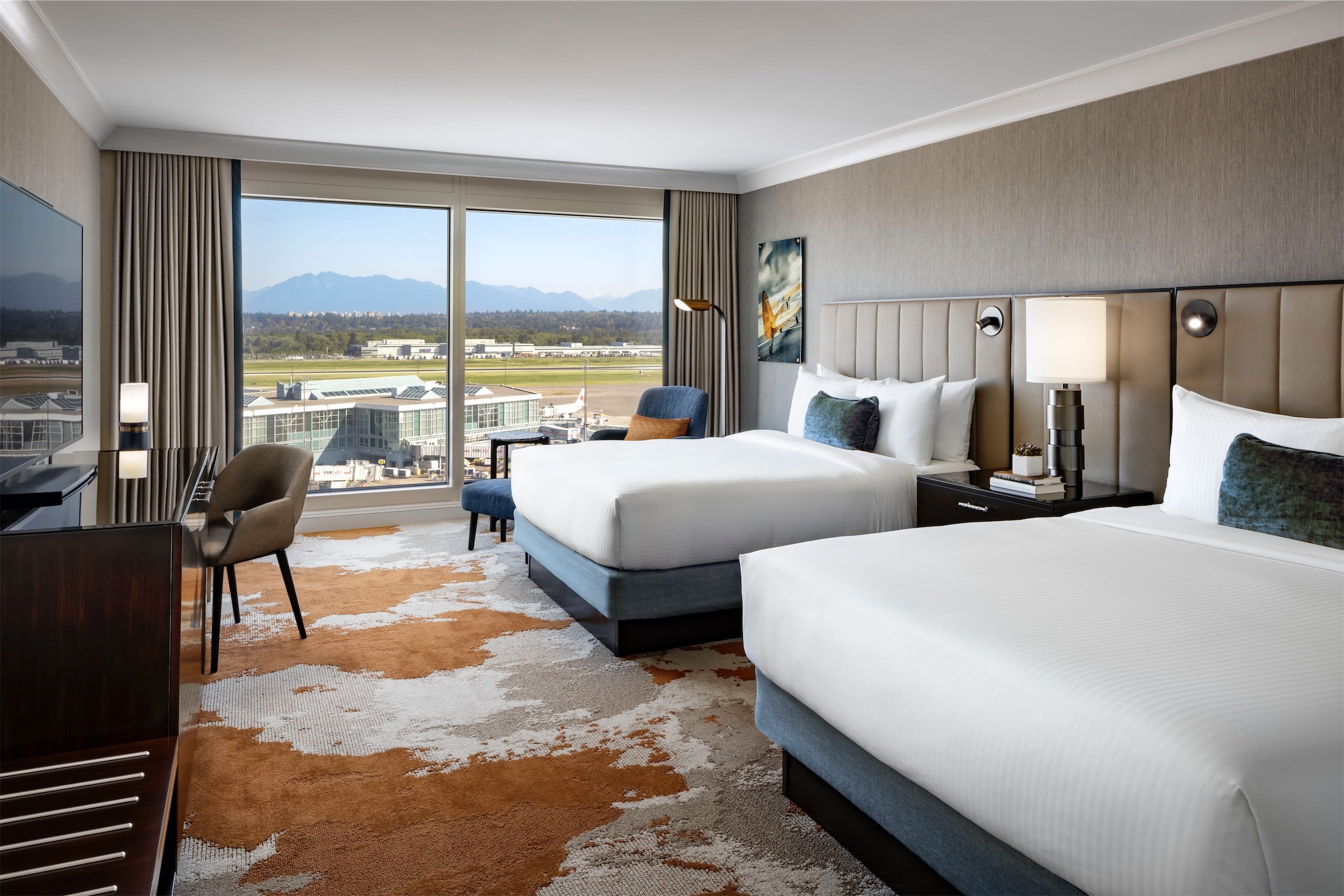 bedroom with two beds and a desk