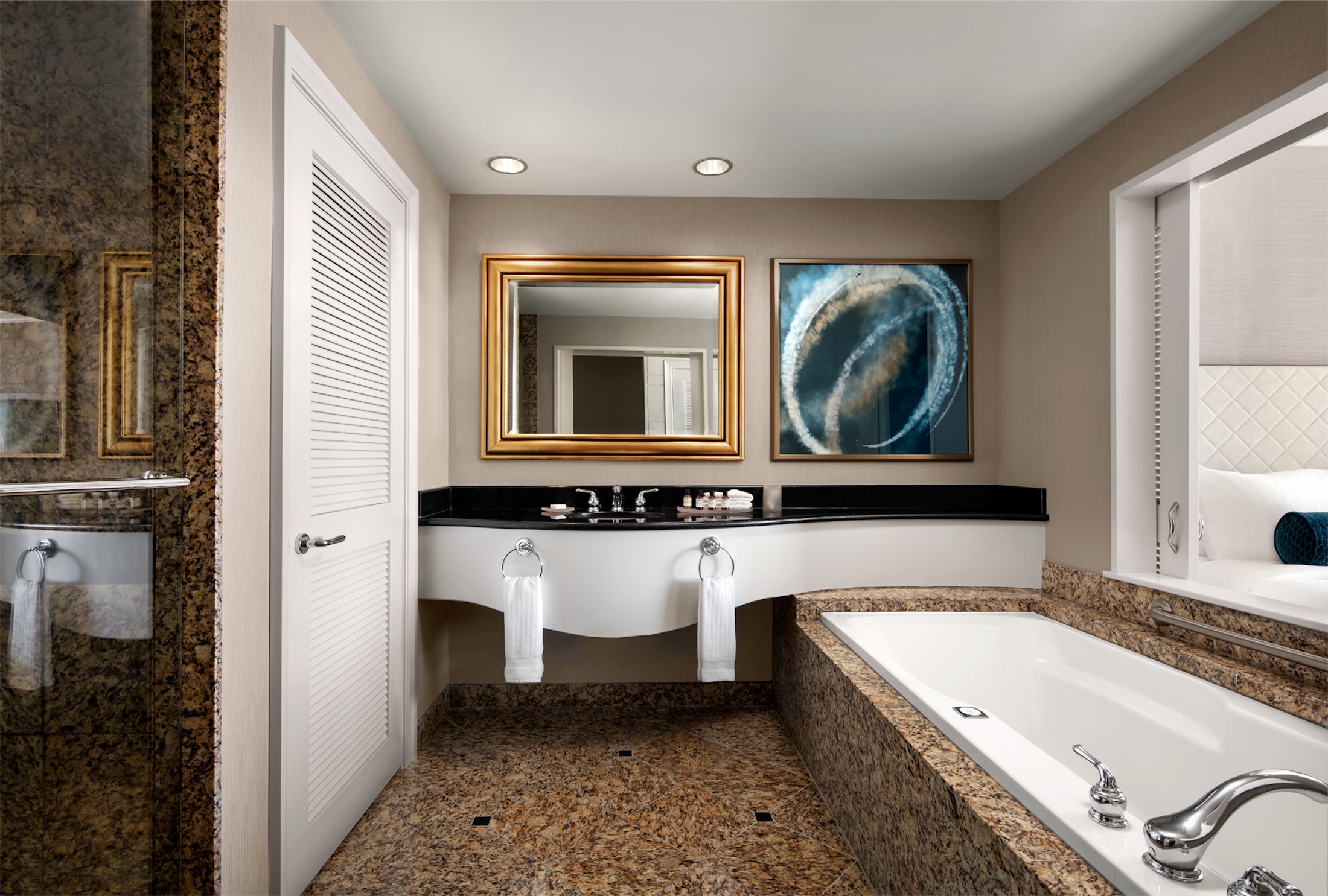 bathroom with a long vanity and tub