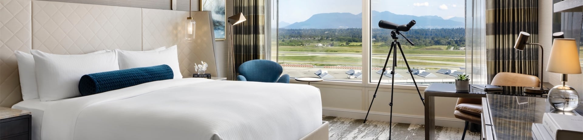 bedroom with a desk and a telescope