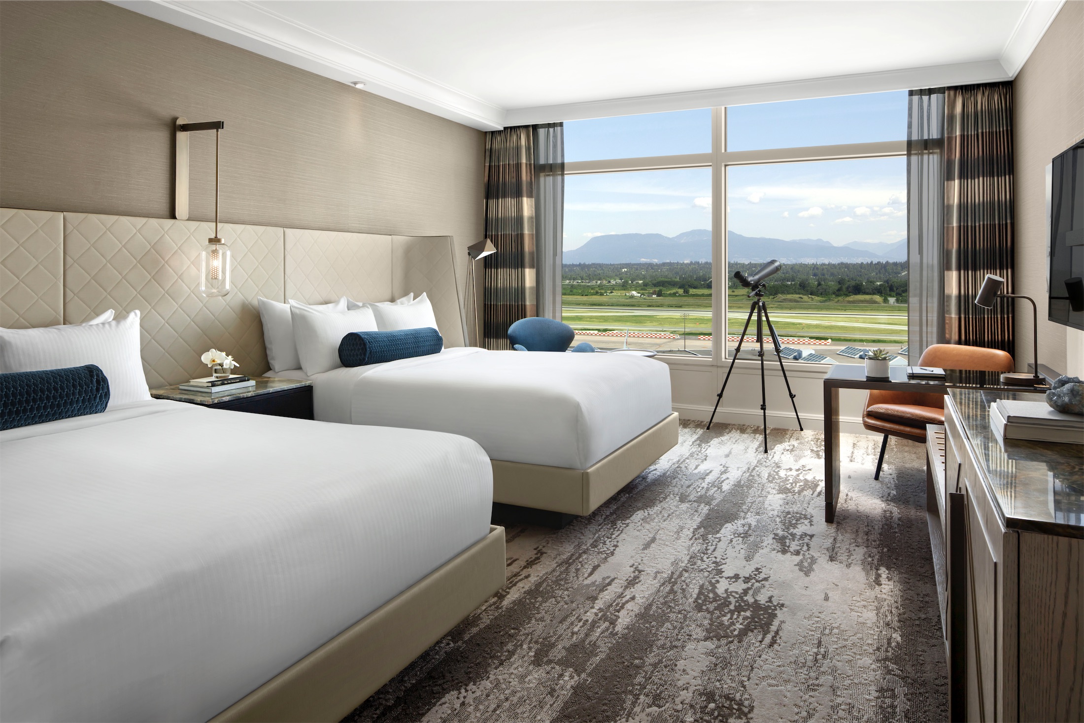 bedroom with two beds, a desk and a telescope