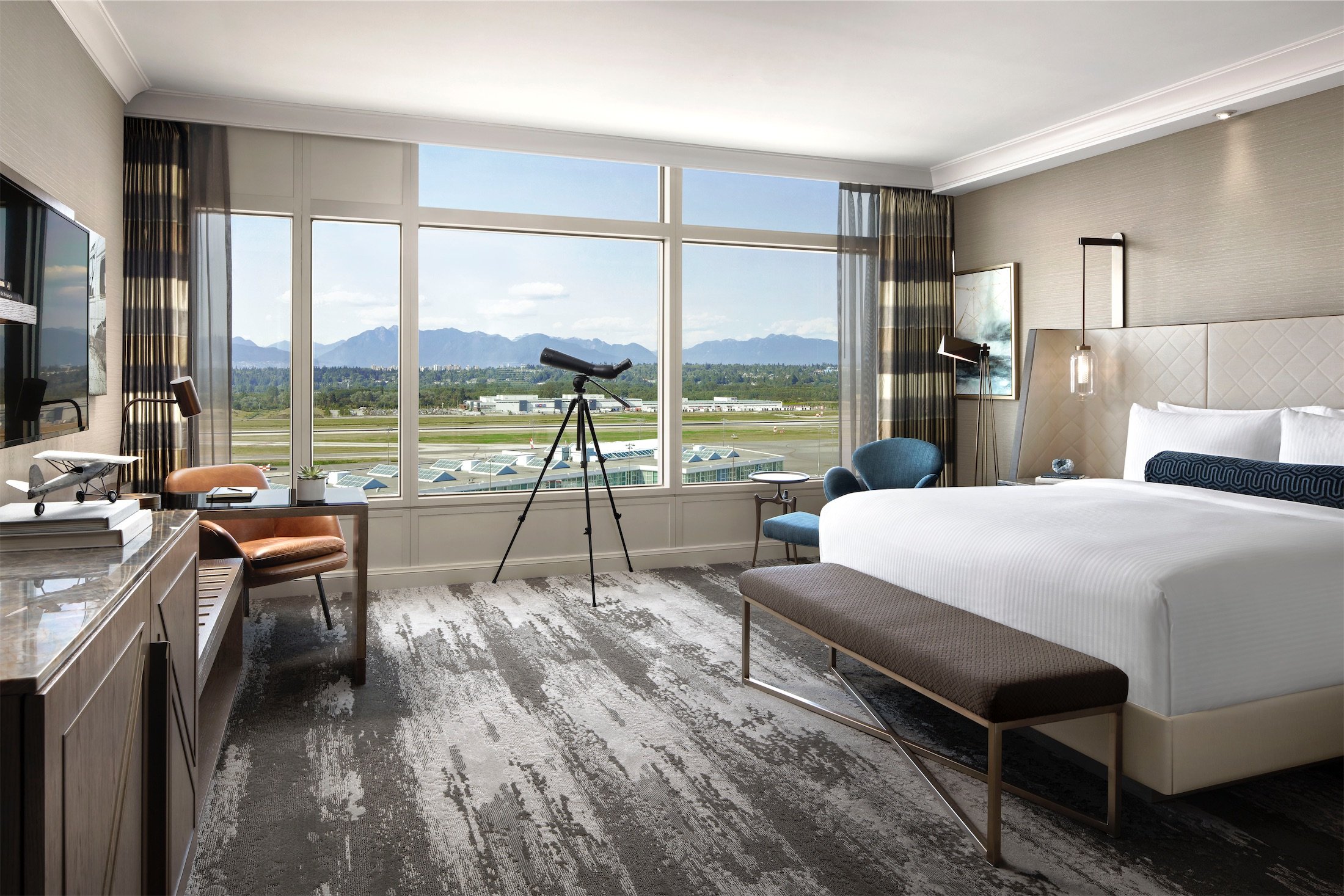 bedroom with a desk and a telescope