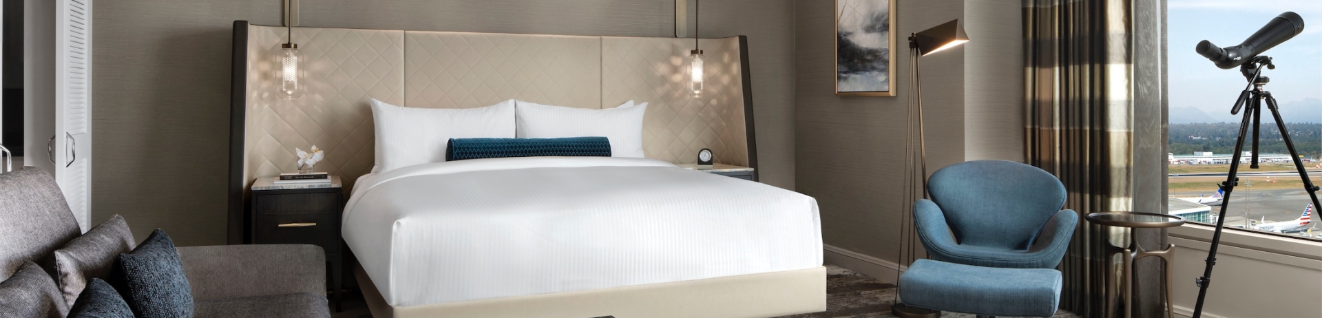 bedroom with a sitting area and a telescope