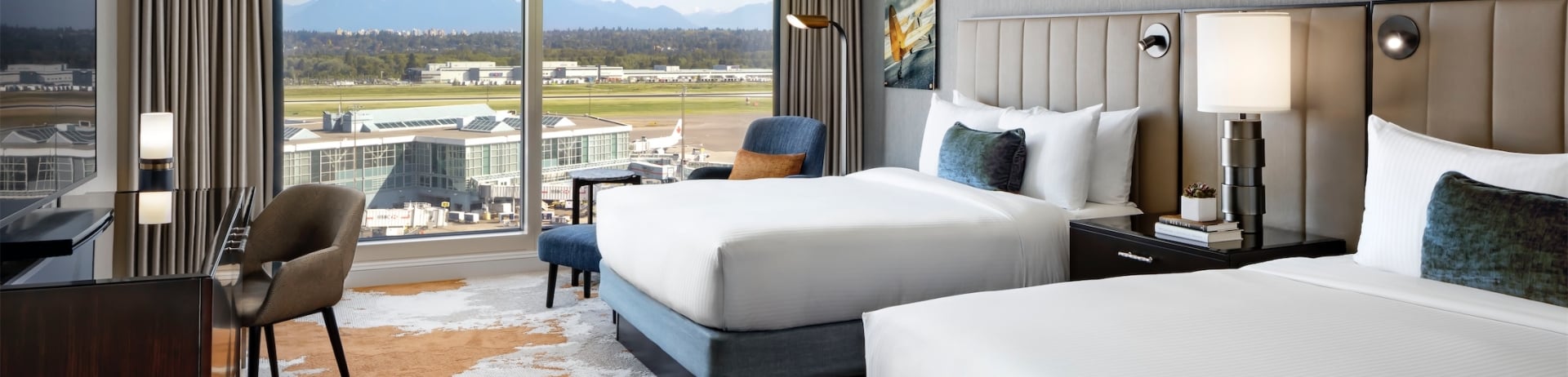 bedroom with two beds and a desk