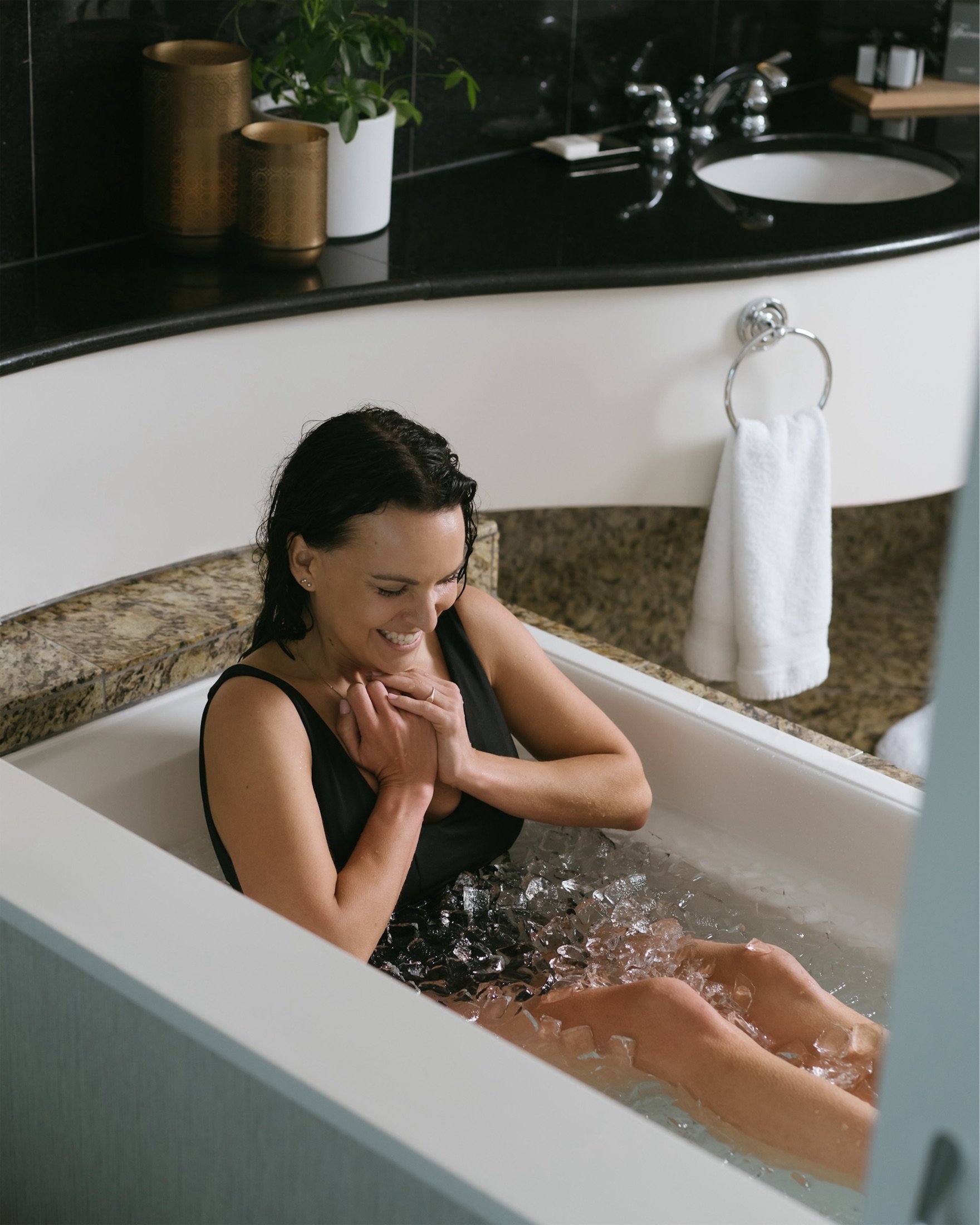 woman in a bathing suit in a tub filled with ice