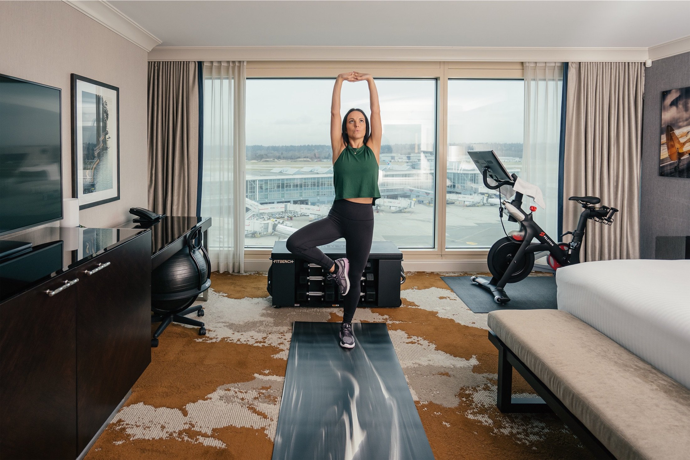 woman doing tree pose on a yoga mat