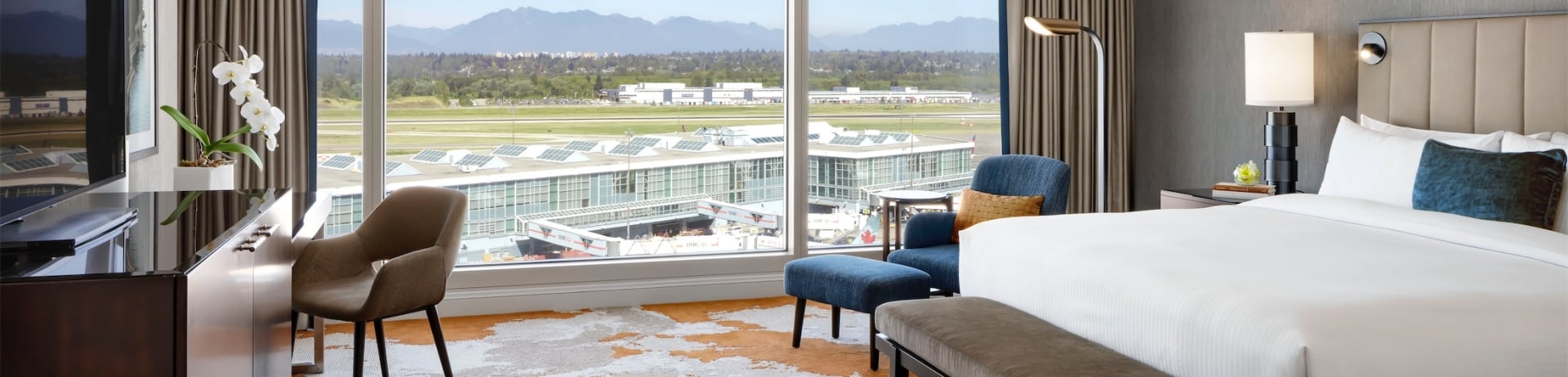 bedroom with blue chair and desk