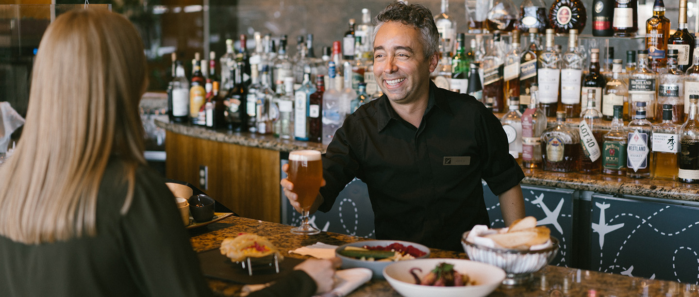 bartender giving customer a beer