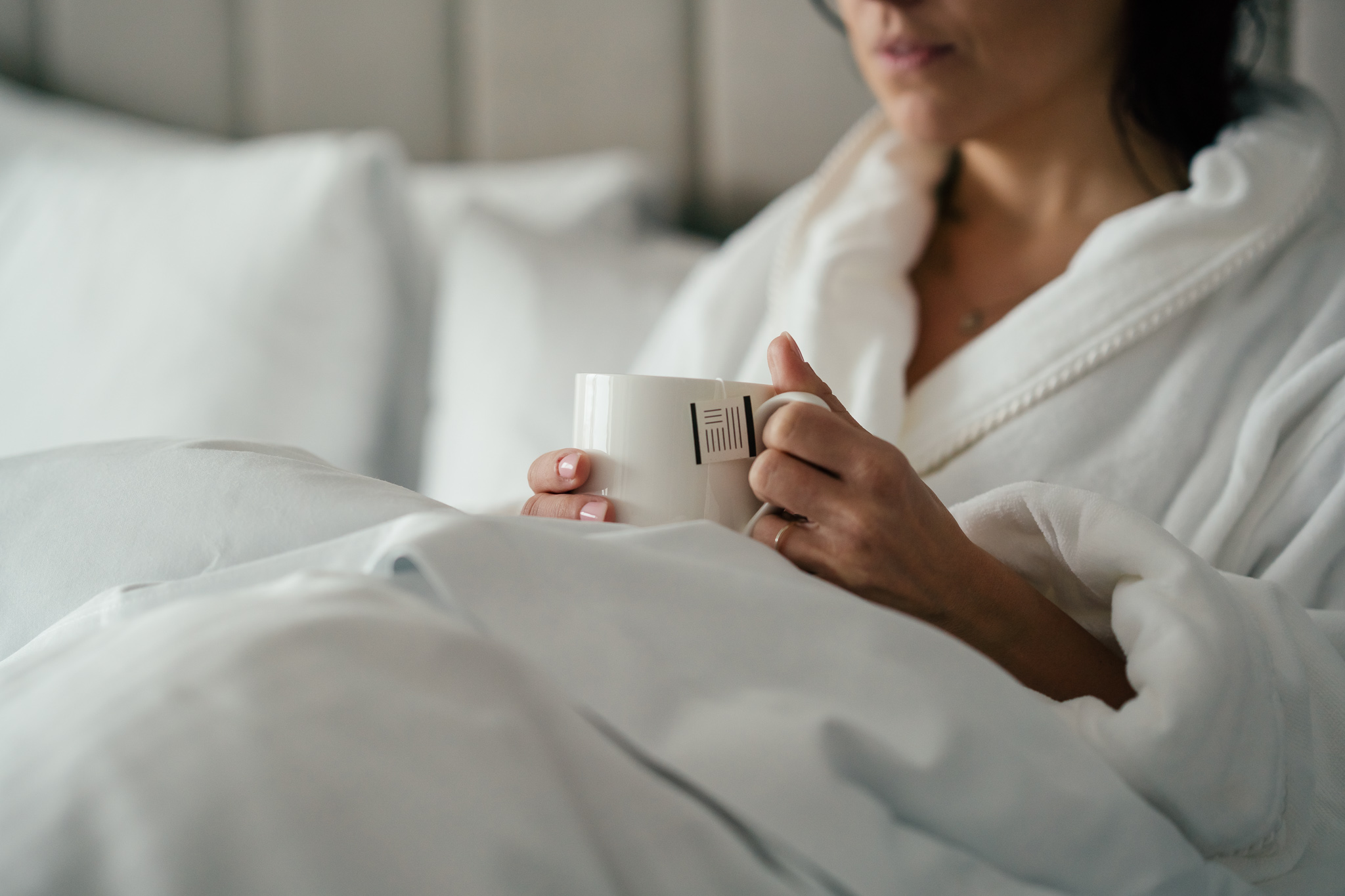 woman drinking tea in bed