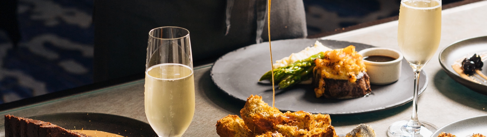 Chef plating dinner with champagne flutes