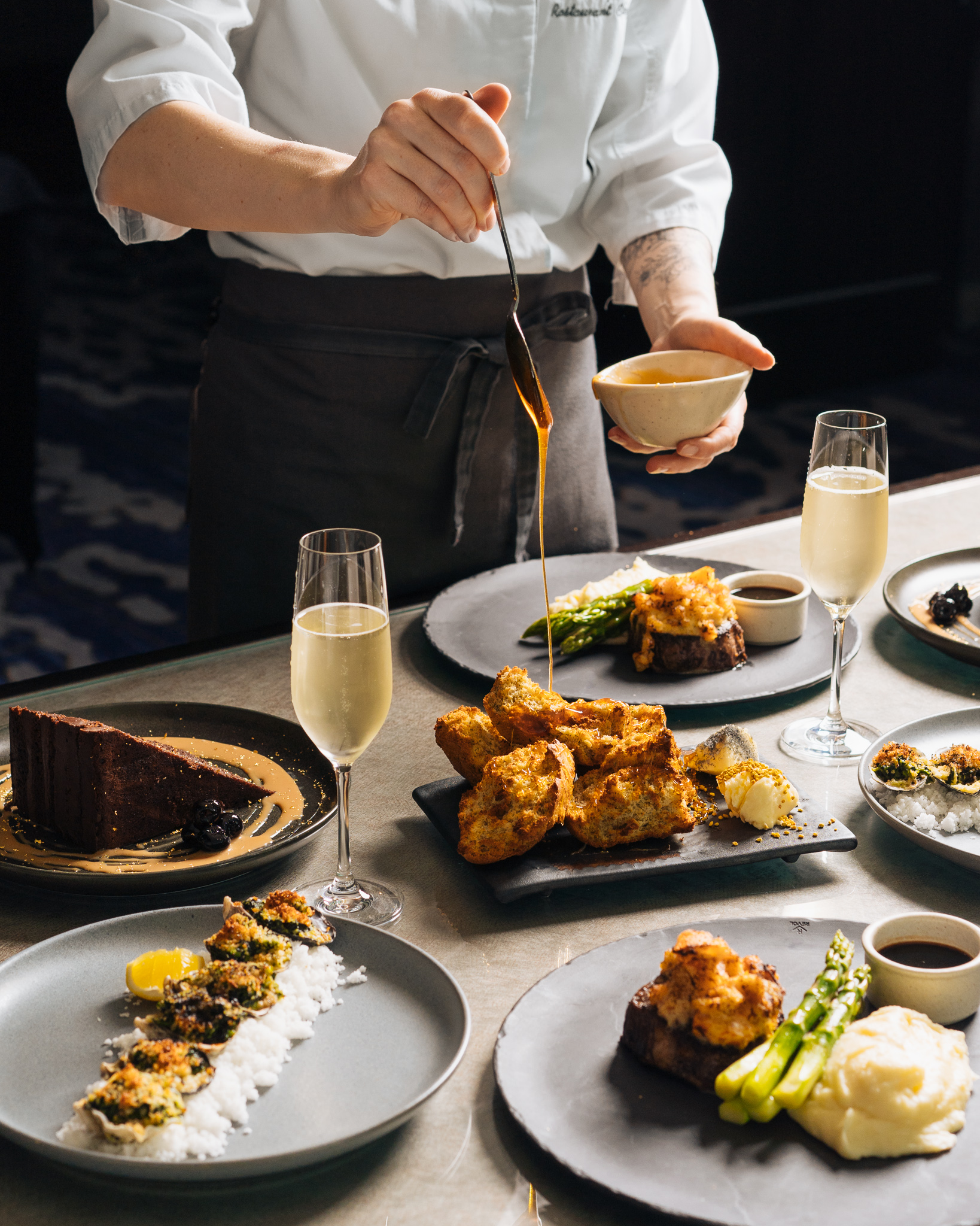 Chef plating dinner with champagne flutes